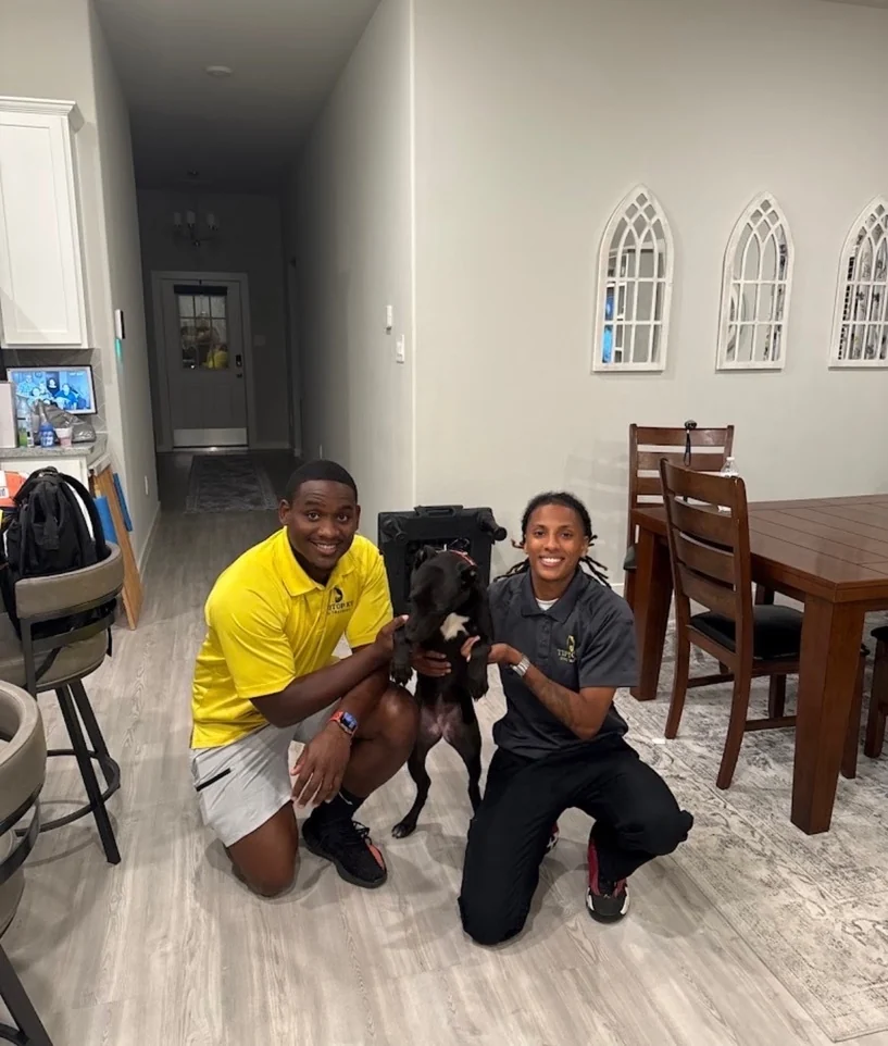 Tip Top K9 Humble trainers starting a client's puppy on early foundations near Kingwood